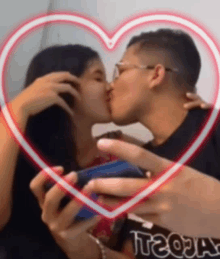 a man and woman kissing in front of a heart with the word tequila written on it