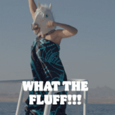 a woman wearing a unicorn mask with the words what the fluff written below her