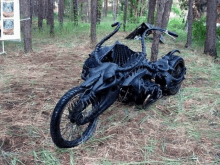 a motorcycle that looks like a skeleton is parked in the grass