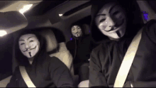 three people wearing masks in a car with seat belts