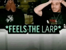 a man is sitting at a table with a sign that says `` feels the larp '' .