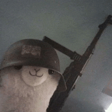 a stuffed animal wearing a helmet is holding a gun .