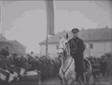 a black and white photo of a man riding a white horse with the words erdely gyar on the bottom