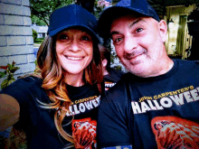 a man and a woman wearing shirts that say john carpenter 's halloween