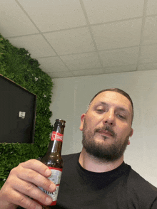 a man holding a budweiser bottle in his hand