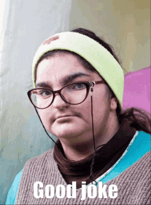 a woman wearing glasses and a headband with the words good joke written on it