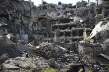 a large pile of rubble sits in front of a large building