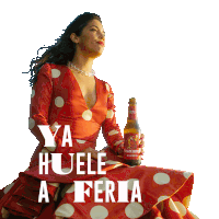 a woman in a red and white polka dot dress holds a bottle of tuscan pilsner