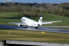 a iran air plane is taking off from an airport runway