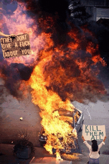 a woman holds up a sign that says kill them all