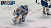 a hockey player with the number 30 on his jersey is kneeling down on the ice