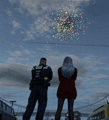 a man and a woman are watching fireworks and the man is wearing a vest that says " tallinn eline eseu "