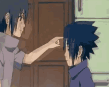 itachi and sasuke are standing next to each other and itachi is pointing at sasuke 's face .