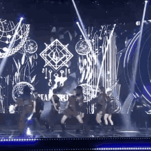 a group of people are dancing on a stage with a logo that says dreamcatcher