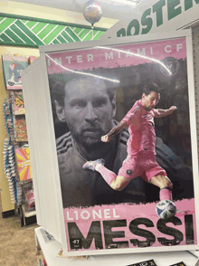 a framed poster of lionel messi in a pink shirt