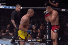 two men are fighting in a boxing ring with the ufc logo on the corner