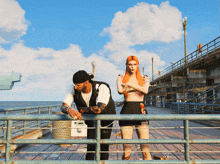 a man and a woman standing on a pier looking out over the ocean