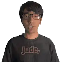 a man wearing glasses and a black shirt that says jude on it