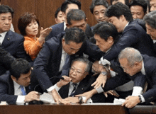 a group of people are fighting over a table