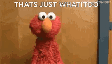 elmo from sesame street is standing in front of a brown wall and says `` that 's just what it do '' .