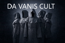 a group of people wearing hooded cloaks are standing next to each other in a dark room .