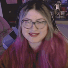 a woman wearing glasses and headphones is making a funny face .