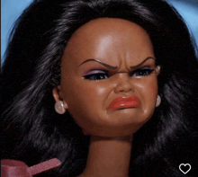 a close up of a barbie doll making a face