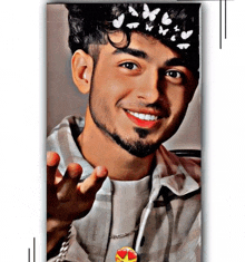 a young man with a headband of butterflies on his head