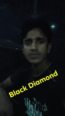 a man wearing a black shirt with the words black diamond on it