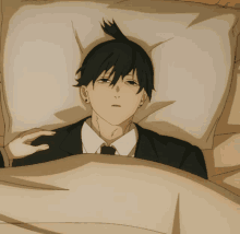 a man in a suit is laying in a bed