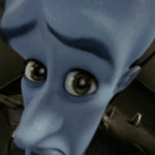 a close up of a blue cartoon character with green eyes .