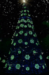 a blue christmas tree with green snowflakes and a star on top
