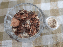 a glass bowl filled with crumbs next to a small jar