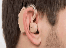 a close up of a man wearing a hearing aid in his ear .