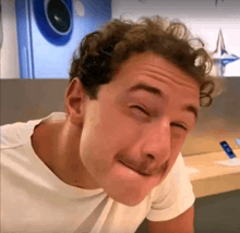 a man with curly hair making a funny face