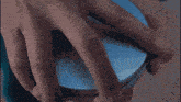 a close up of a person 's hands holding a spoon .