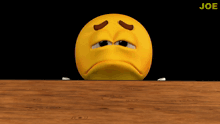 a sad smiley face with a black background and the word joe in the corner