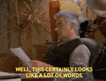 a man sits at a desk reading a piece of paper with the words well this certainly looks like a lot of words