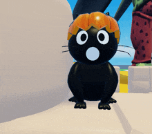 a black cat with a pumpkin hat on its head