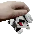 a person is petting a stuffed animal that looks like a wolf .