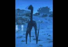 a statue of a giraffe is standing in the middle of a snowy field .