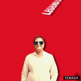 a man wearing sunglasses stands in front of a red background with legend lovers written on it