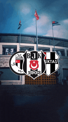 a black and white logo for bjk 1903 sits in front of a building