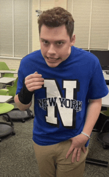 a man wearing a blue t-shirt that says new york on it