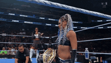 a woman in a wrestling ring with a bottle of milk in the background