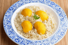 a bowl of rice with yellow eggs on top