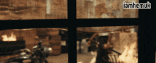 a motorcycle is parked in front of a window with the words iamhemuk written above it