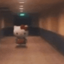 a hello kitty doll is walking down a hallway in a blurry photo .