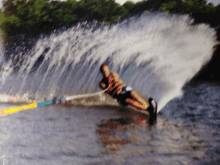 a person is water skiing on a lake and the water is spraying