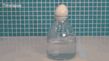 a bottle of water is being poured into a glass